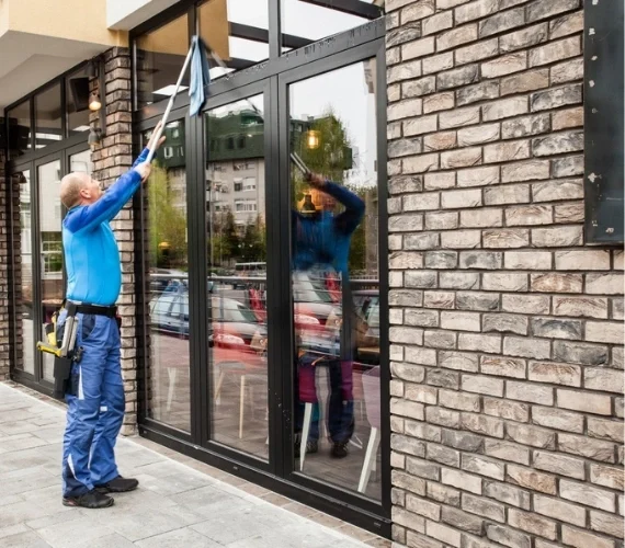 A uniformed professional cleaner providing reliable home and office cleaning services in Gibraltar, ensuring a spotless and hygienic interior workspace.